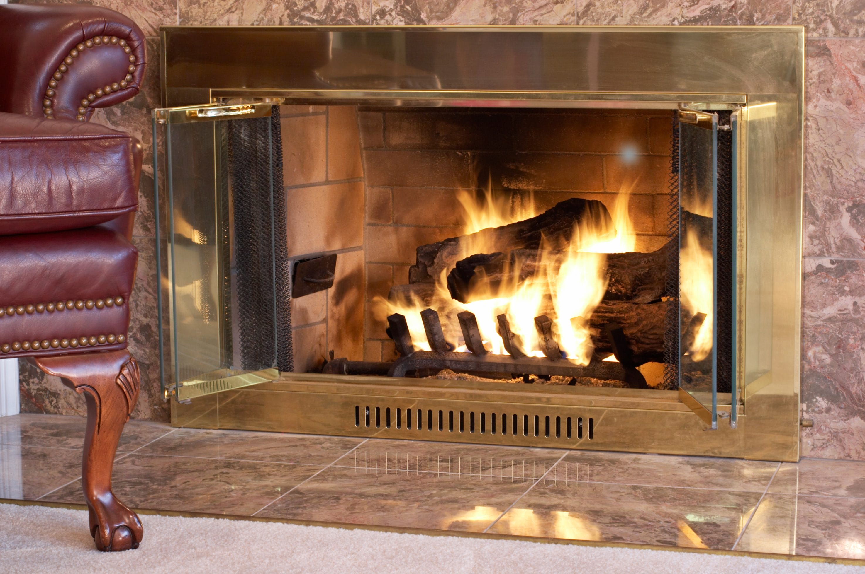 A gas fireplace with a roaring fire.